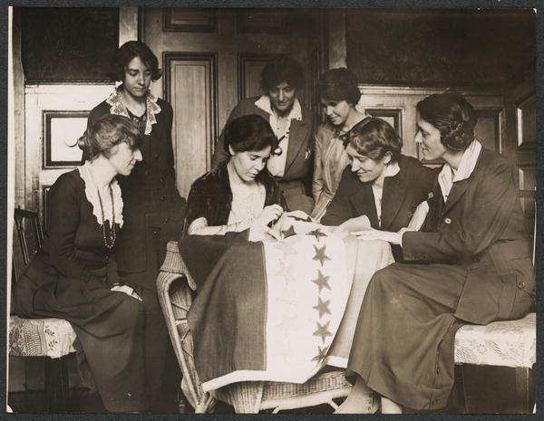 Alice Paul sews the last flag on to the 19th Amendment ratification banner